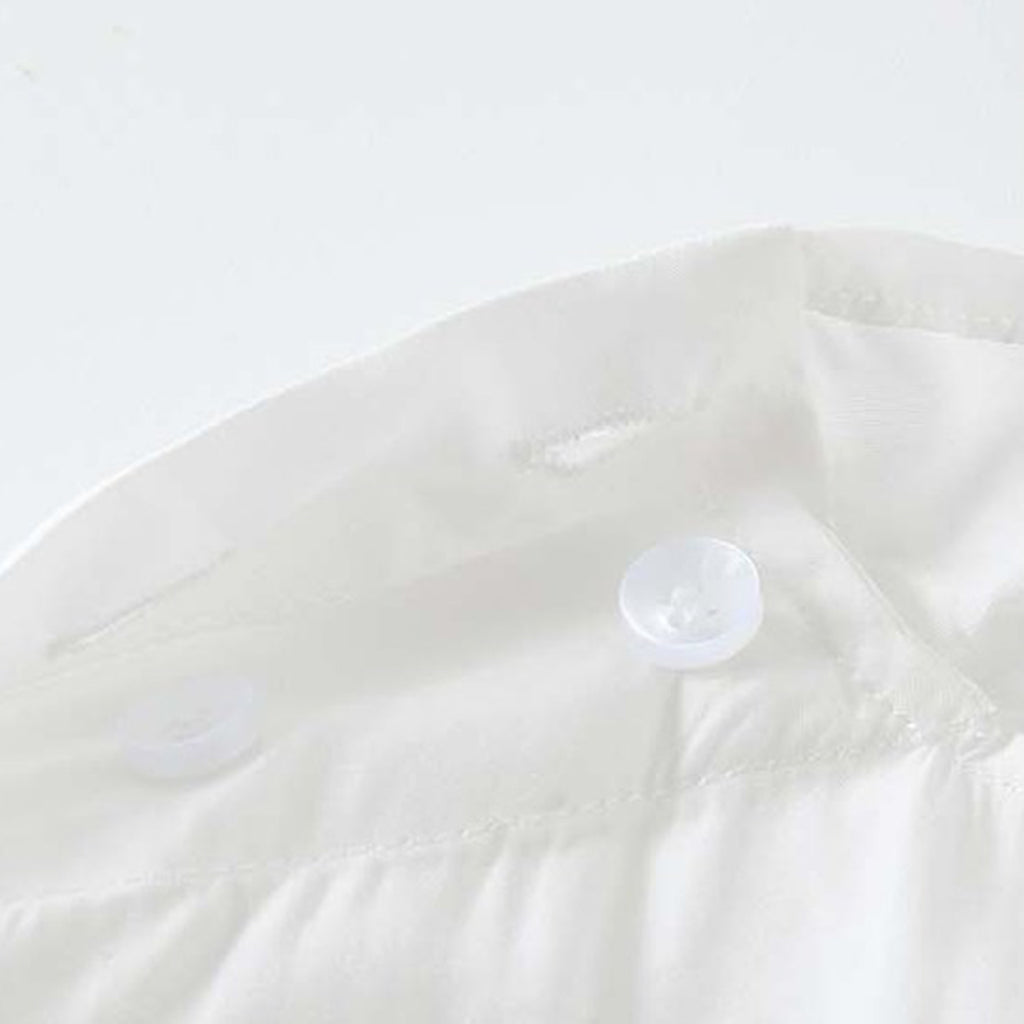Asymmetric diagonal buckle strap waist cinching shirt top