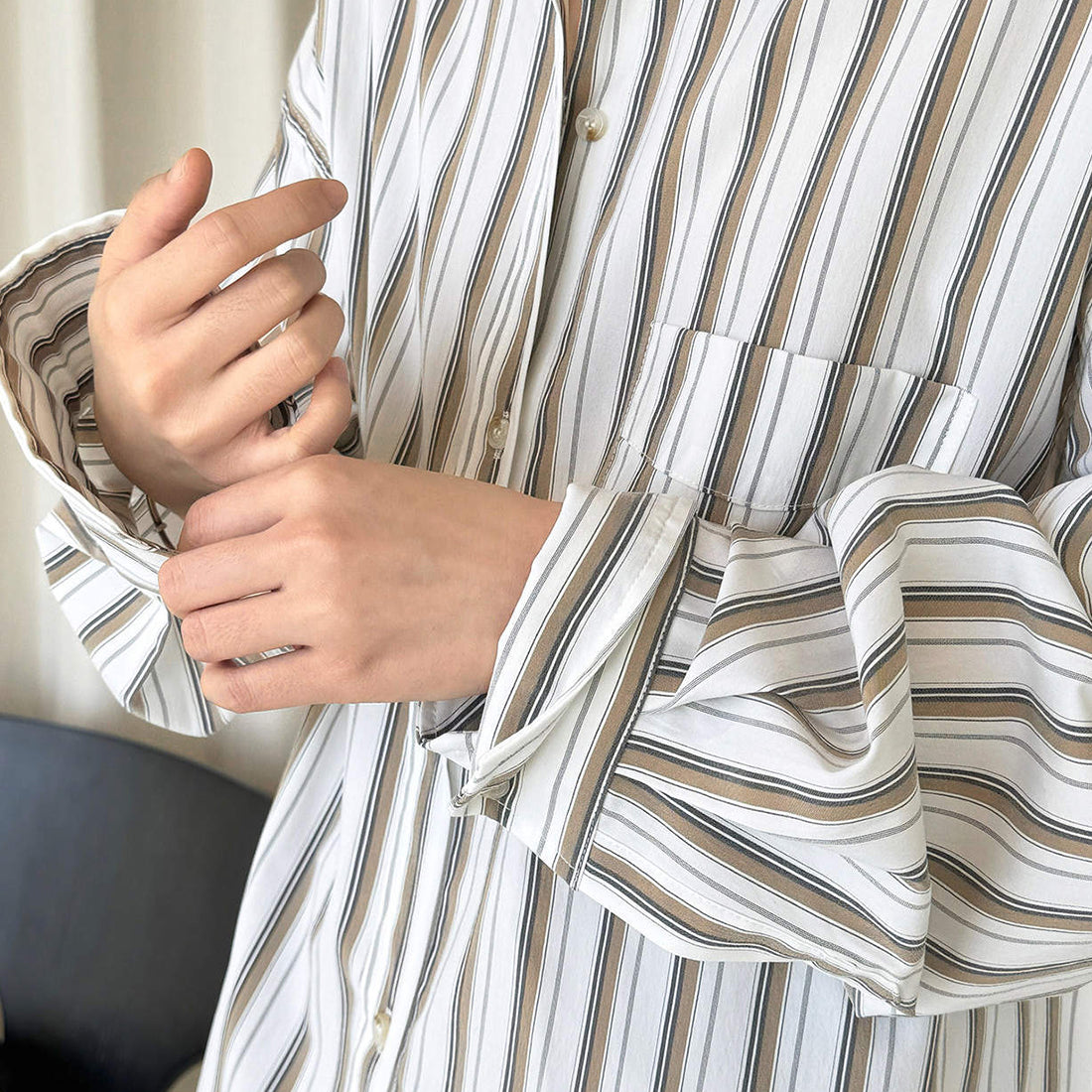 Striped long sleeved loose silhouette slimming shirt top