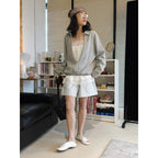 Oversized V-neck pullover sweatshirt with raw edge collar and relaxed fit