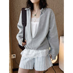 Oversized V-neck pullover sweatshirt with raw edge collar and relaxed fit