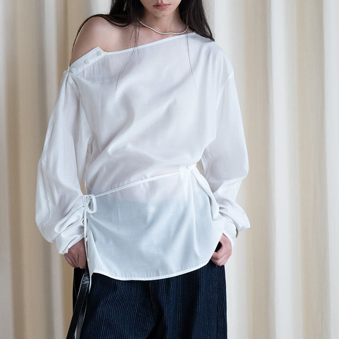 Asymmetric diagonal buckle strap waist cinching shirt top