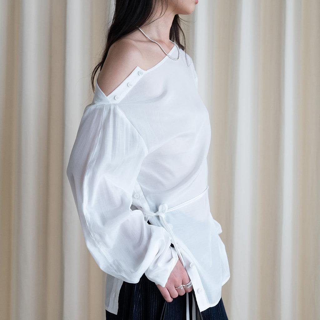 Asymmetric diagonal buckle strap waist cinching shirt top