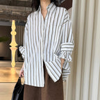 Striped long sleeved loose silhouette slimming shirt top