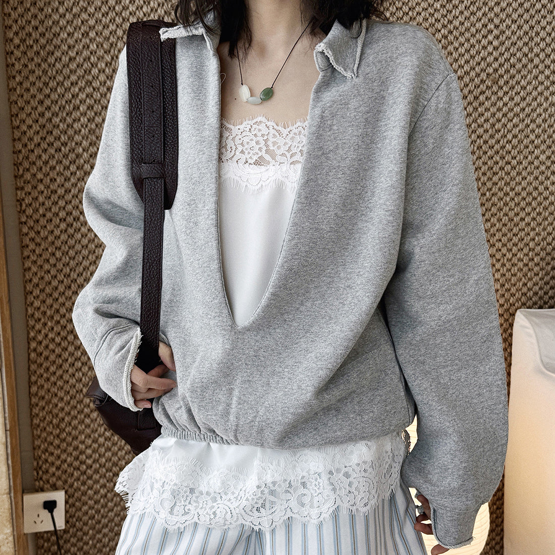 Oversized V-neck pullover sweatshirt with raw edge collar and relaxed fit