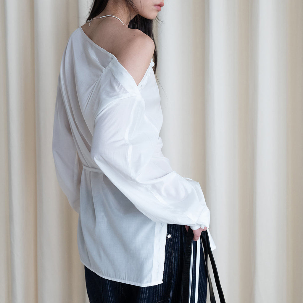 Asymmetric diagonal buckle strap waist cinching shirt top