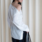 Asymmetric diagonal buckle strap waist cinching shirt top