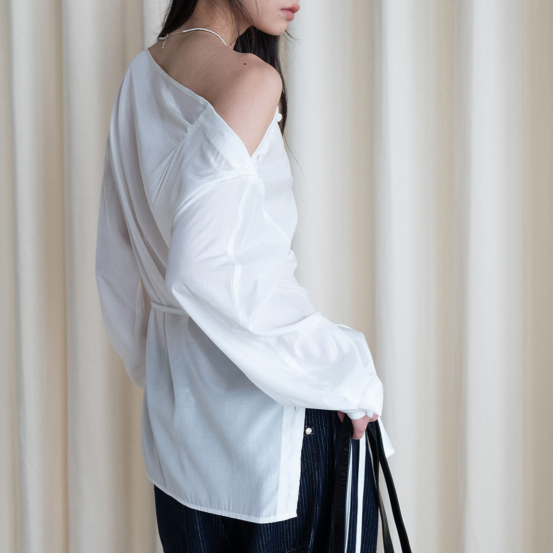 Asymmetric diagonal buckle strap waist cinching shirt top