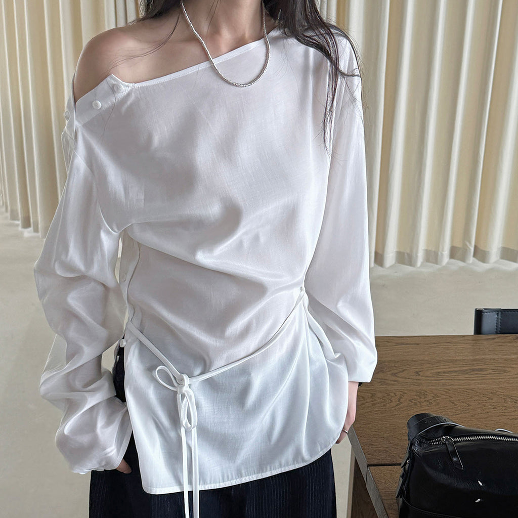 Asymmetric diagonal buckle strap waist cinching shirt top
