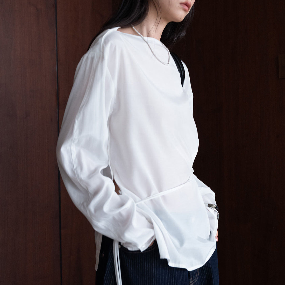 Asymmetric diagonal buckle strap waist cinching shirt top