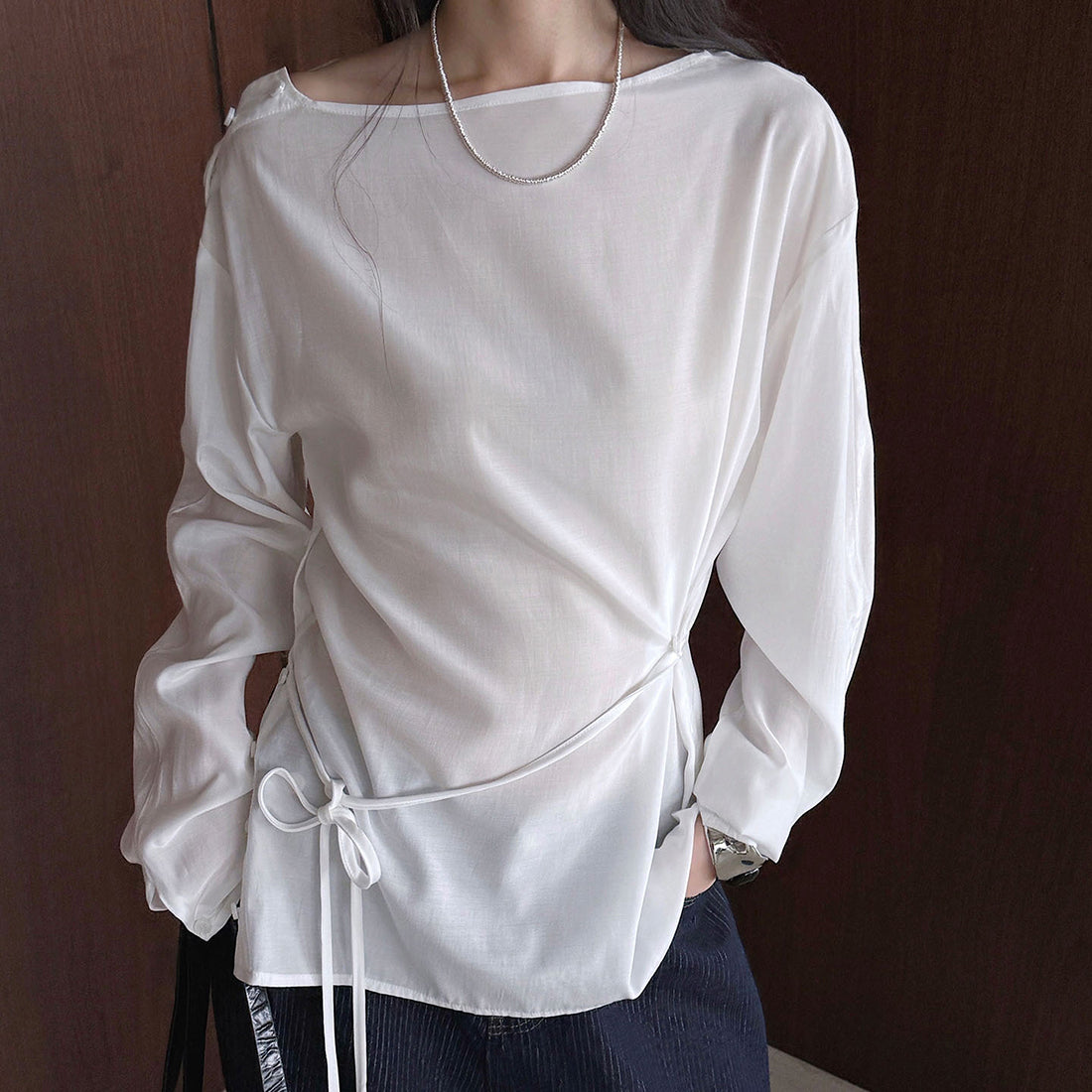 Asymmetric diagonal buckle strap waist cinching shirt top